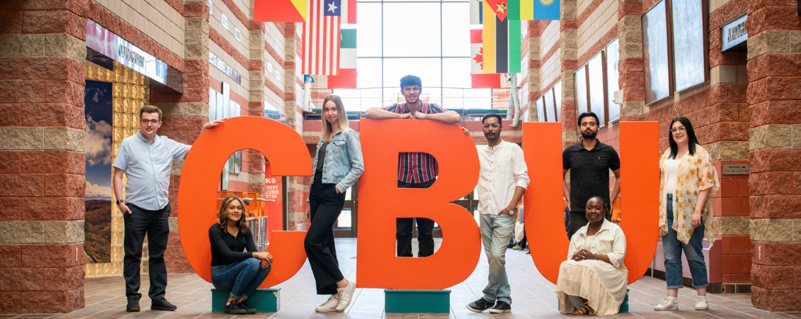 Students gathered around a sign.