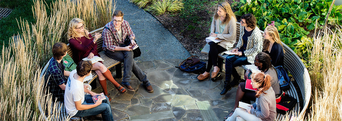 A group of female and male students gathered to discuss course work at the University of King's College