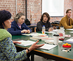 Two female adult learners in a post-secondary class with two younger male students